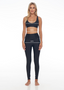 Rozal Active model showing how to measure inseam and waist – wearing Nero black PowerFlex leggings, women’s gym wear sizing guide.